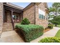 Inviting front porch with rocking chairs, stone facade, and landscaping at 7440 Bleasdale Ct, Apex, NC 27539