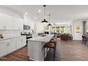 Modern kitchen with white cabinets, granite countertops, and large island at 776 Denburn Pl, Raleigh, NC 27603