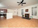Bright living room boasts recessed lighting, neutral walls, tile floors, fireplace, and large windows with plantation shutters at 9412 Harvest Acres Ct, Raleigh, NC 27617