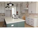 Kitchen with island, quartz countertops, stainless appliances and neutral backsplash at 1021 Smoke Willow Way # 130, Rolesville, NC 27571
