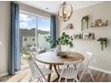 Bright dining area with a round wooden table and access to a patio at 104 Kobus Ct, Garner, NC 27529