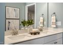 Modern bathroom featuring double sinks, a sleek mirror, and stylish decor at 119 Siebold St, Garner, NC 27529