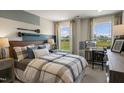 Cozy bedroom with a comfortable bed, built-in desk, and ample closet space at 119 Siebold St, Garner, NC 27529