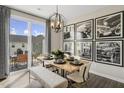 Dining room with sliding glass doors leading to backyard, six chairs, and a gallery wall at 120 Kobus Ct, Garner, NC 27529