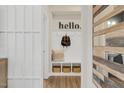 Bright entryway with white bench, cubbies, and a wooden wall accent at 120 Kobus Ct, Garner, NC 27529