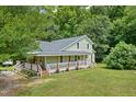 House exterior showcasing wrap around porch at 1610 Woodards Dairy Rd, Middlesex, NC 27557