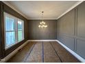 Dining room with modern wainscoting, large window and contemporary lighting at 190 Broadleaf Ln, Louisburg, NC 27549