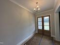 Dining room featuring double doors and stylish light fixture at 190 Broadleaf Ln, Louisburg, NC 27549