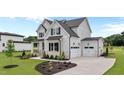 Stunning two-story home with a spacious three-car garage and manicured landscaping at 190 Broadleaf Ln, Youngsville, NC 27596