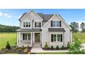 Charming two-story home featuring a covered porch, stone accents, and professional landscaping at 190 Broadleaf Ln, Youngsville, NC 27596