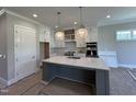 Bright kitchen with a large island, modern appliances, and stylish pendant lighting at 190 Broadleaf Ln, Youngsville, NC 27596