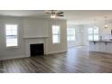Bright living room featuring a fireplace, lots of natural light, and hardwood floors at 24 Surles Landing Way, Benson, NC 27504