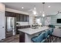 Open concept kitchen features stainless steel appliances and granite island at 2907 Huxley Way, Apex, NC 27502
