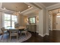 Elegant dining room with a round table, chandelier, and hardwood floors at 2940 Hanging Valley Way, Wake Forest, NC 27587