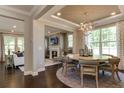 Open concept dining room with a large table and access to the Gathering room at 2940 Hanging Valley Way, Wake Forest, NC 27587