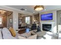 Open living room with fireplace, large windows, and comfortable seating at 2948 Hanging Valley Way, Wake Forest, NC 27587