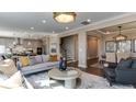 Open living space with gray sofas, a large TV, and a view into the dining area at 2948 Hanging Valley Way, Wake Forest, NC 27587