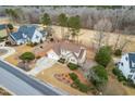 Aerial view of home with golf course behind it, showcasing the landscape, the driveway, and neighboring houses at 306 Neuse Ridge Dr, Clayton, NC 27527