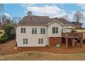 Expansive back of house featuring a raised deck with a shade umbrella, perfect for outdoor relaxation at 306 Neuse Ridge Dr, Clayton, NC 27527