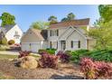 Attractive home with a well-landscaped front yard, showcasing colorful plants and enhancing curb appeal at 306 Neuse Ridge Dr, Clayton, NC 27527