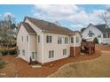 Rear exterior view featuring a deck, neutral siding, and multiple windows for ample natural light at 306 Neuse Ridge Dr, Clayton, NC 27527