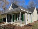 Gray siding home with a covered porch and green door at 415 Sowell St, Durham, NC 27701