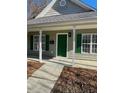 Green front door entry to a charming house at 415 Sowell St, Durham, NC 27701