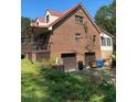 Brick home with attached two-car garage, red roof, and spacious porch at 515 Docs Rd, Lillington, NC 27546