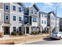 Row of three story townhouses with gray siding and gray roofs at 5940 Illuminate Ave, Raleigh, NC 27616