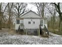 Rear view of a white duplex with stairs and HVAC units at 645 Arch St, Henderson, NC 27536