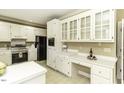 White kitchen cabinets, stainless steel appliances, and a built-in desk area at 805 Joshua Clay Dr, Rocky Mount, NC 27803