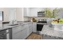 Modern kitchen with granite countertops and stainless steel appliances at 8630 Brixton Shay Dr, Raleigh, NC 27616
