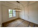 Bright dining room with decorative molding and a modern chandelier, perfect for entertaining guests at 90 Firefly Ln, Louisburg, NC 27549