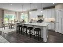 Spacious kitchen with white cabinets, granite countertops, and a large island at 1008 Country Pasture Cv, Wendell, NC 27591