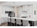 Modern kitchen with white cabinets, large island, and stainless steel appliances at 1020 Country Pasture Cv, Wendell, NC 27591