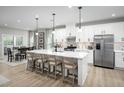 Bright kitchen with white cabinets, stainless steel appliances, and large island with seating for four at 1024 Country Pasture Cv, Wendell, NC 27591