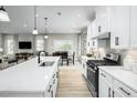 Bright kitchen featuring an oversized island with quartz countertop and stainless steel appliances at 1024 Country Pasture Cv, Wendell, NC 27591