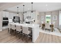 Modern kitchen features a large island with seating, stainless appliances, and adjacent dining area at 1024 Country Pasture Cv, Wendell, NC 27591