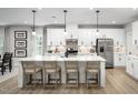 Bright kitchen with white cabinets, stainless steel appliances, and large island with seating at 1024 Country Pasture Cv, Wendell, NC 27591