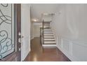 Bright entryway with hardwood floors, staircase, and elegant door at 106 Park Manor Ln, Cary, NC 27519