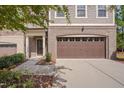 Townhome exterior featuring a brown garage door and walkway at 106 Park Manor Ln, Cary, NC 27519