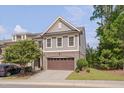Gray townhome exterior with brown garage door and landscaping at 106 Park Manor Ln, Cary, NC 27519