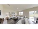 Spacious living room with light neutral colors, comfortable furniture, and large windows at 1070 Parkside Drive, Nashville, NC 27856