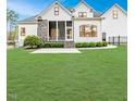 Well-maintained backyard features a stone-accented screened porch and lush green lawn at 120 Crosby Ln, Sanford, NC 27330