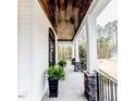 Covered porch with stone columns and dark stained ceiling at 120 Crosby Ln, Sanford, NC 27330