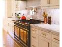 Luxury kitchen with marble countertops and a large range at 1521 Canterbury Rd, Raleigh, NC 27608