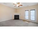 Living room with fireplace and double doors leading outside at 1673 Snowmass Way, Durham, NC 27713