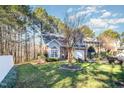 Two-story home with brick accents, an attached garage, a manicured lawn, and mature trees at 2112 White Pond Ct, Apex, NC 27523