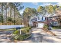 Charming two-story home with a well-manicured lawn, brick accents, and an attached garage at 2112 White Pond Ct, Apex, NC 27523