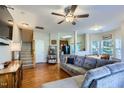 Spacious living room with hardwood floors, a comfortable couch and stairs at 2120 Breezeway Dr # 112, Raleigh, NC 27614